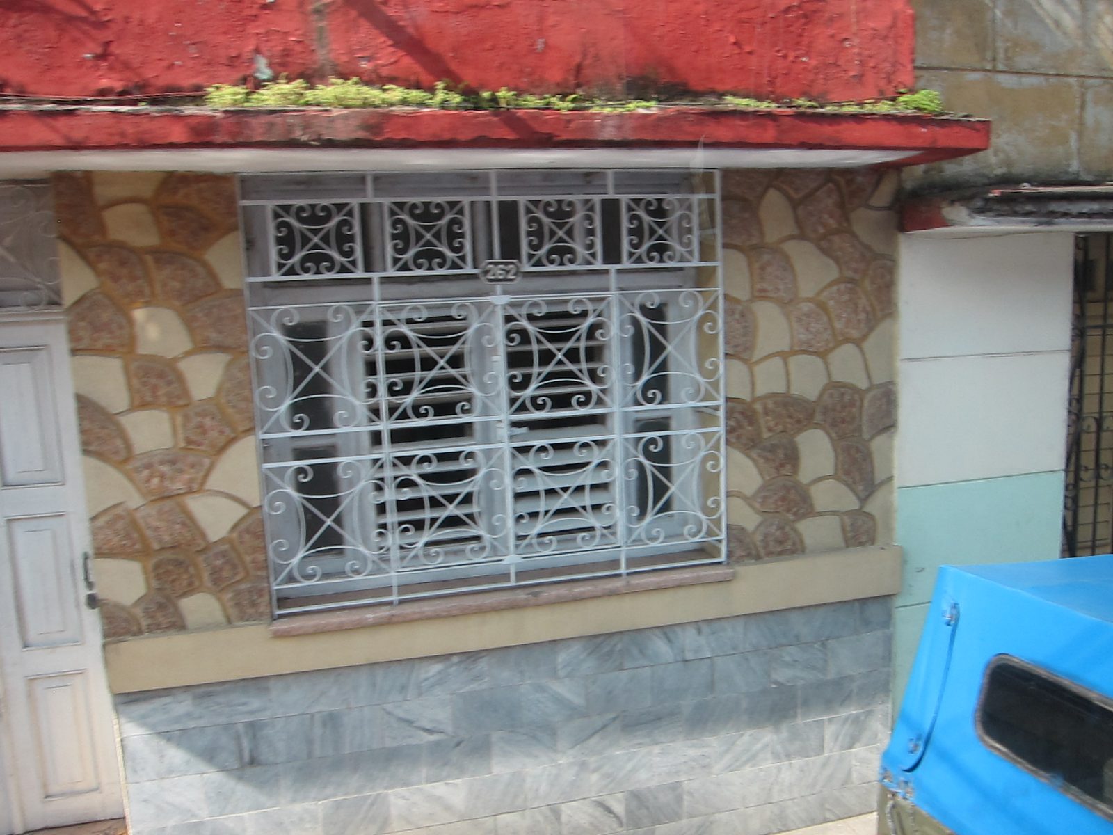 Street side building.  A lot of grills, frequently without glass.  Provides air, security